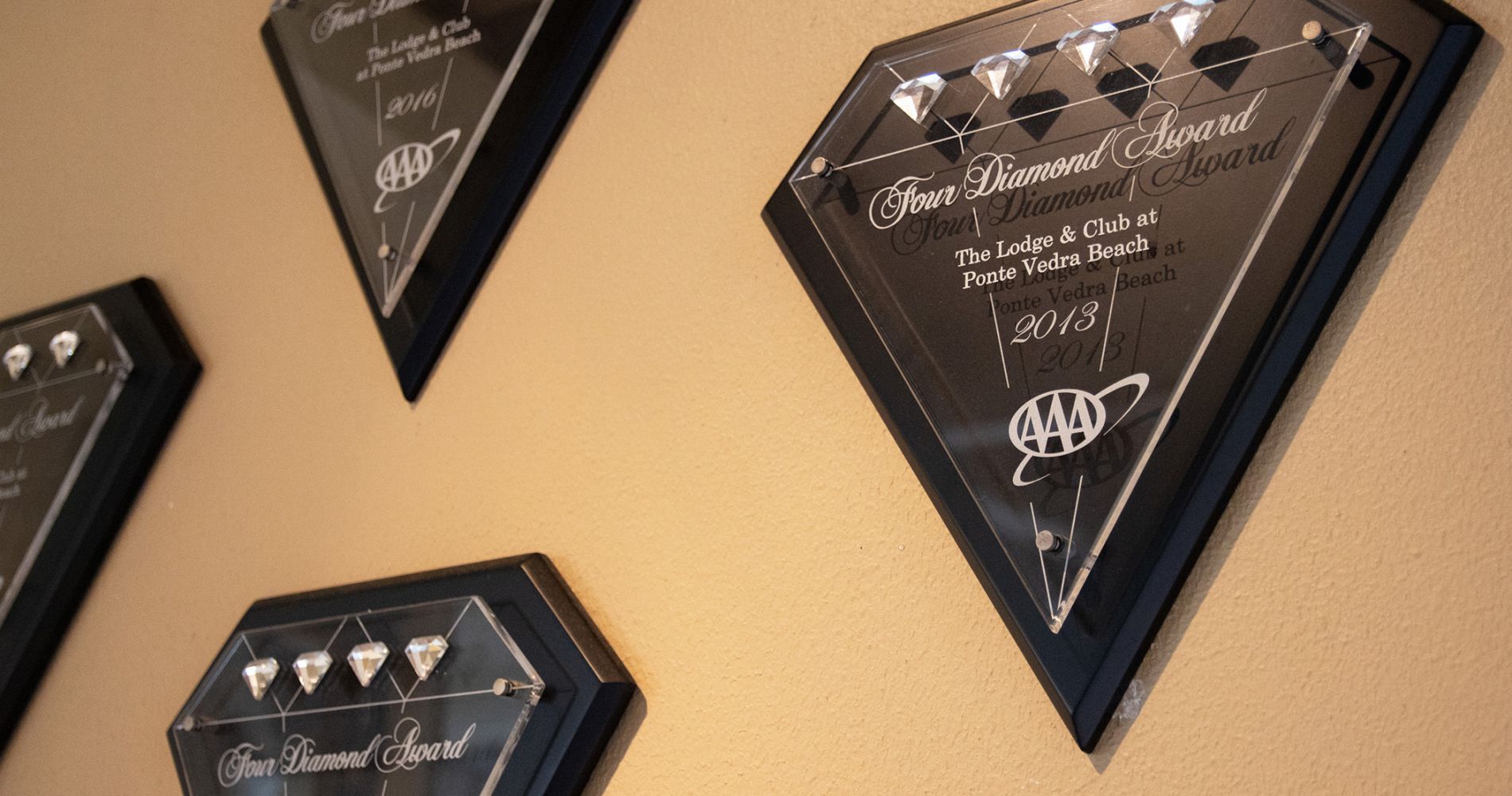 Four AAA Four Diamond awards hanging on a wall