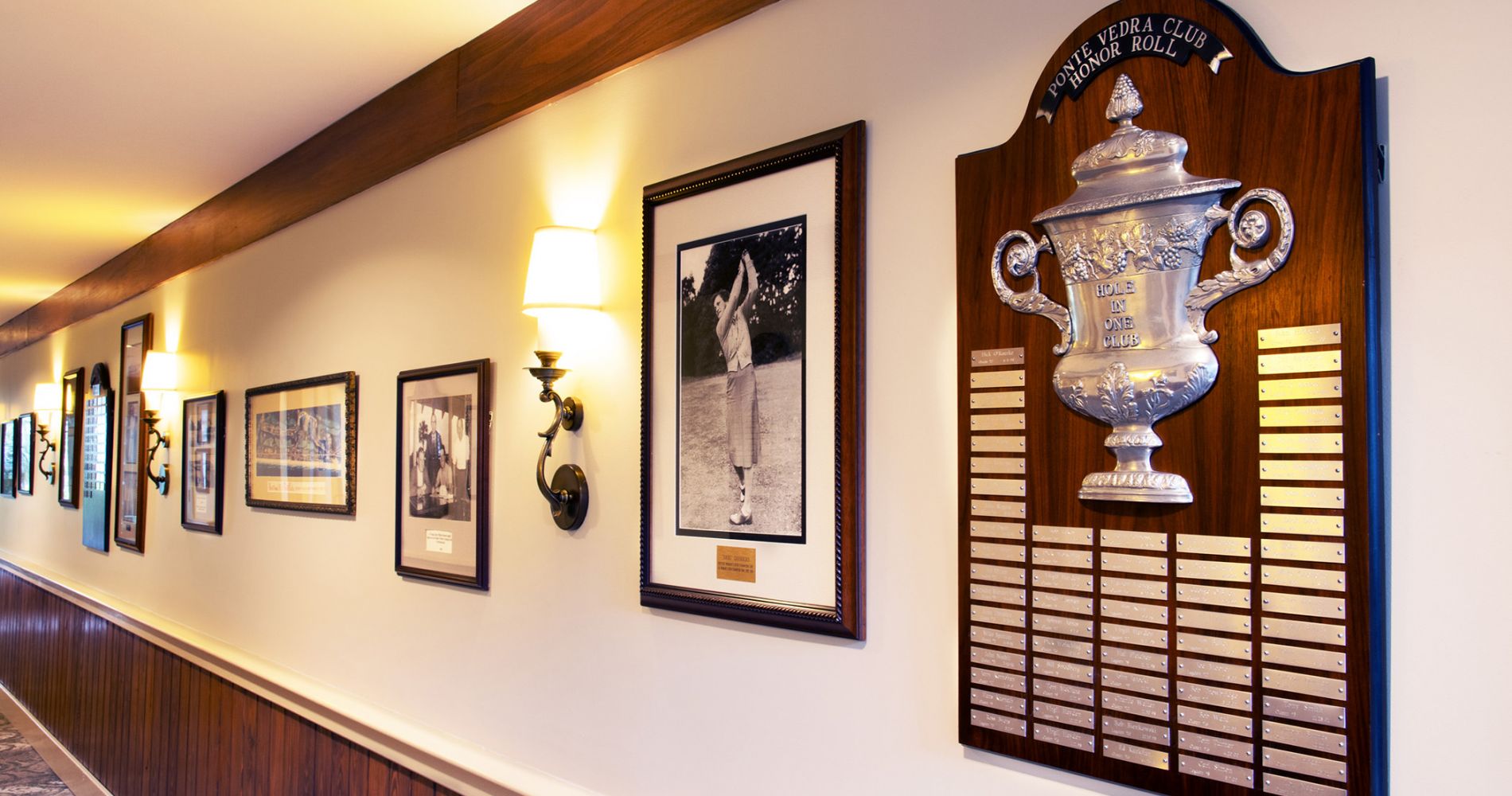 Historic golf photos and plaques on display in the club house hallway