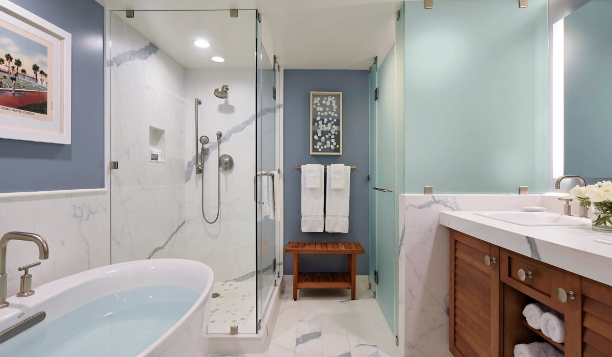 bathroom of the atlantic house with blue walls and wooden vanity