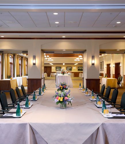 View of a set up meeting table from the end of the table
