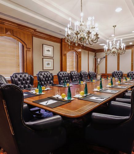 Large boardroom prepped for a meeting with luxurious leather chairs