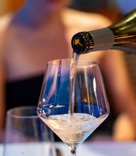 White wine being poured into a glass.