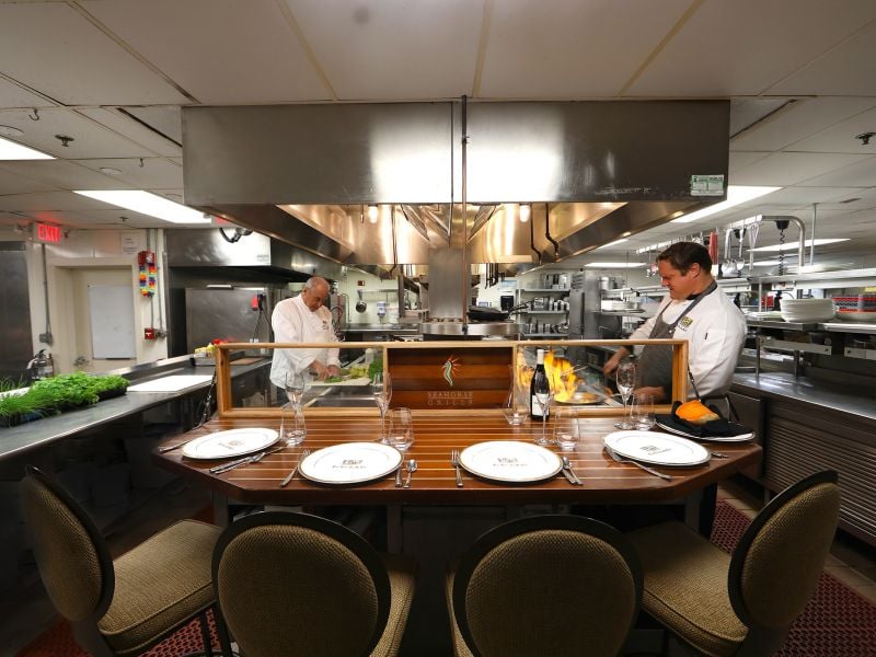 Table for four in front of chefs cooking