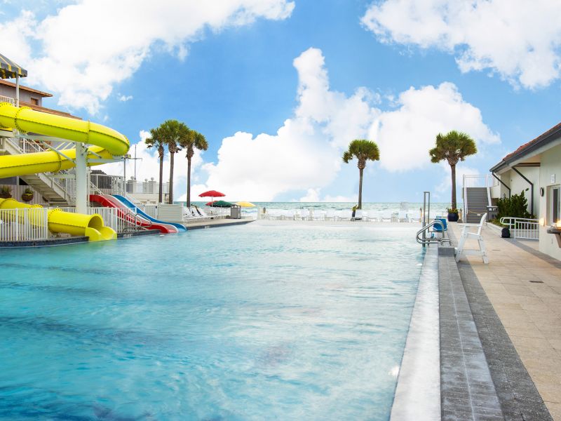 Outdoor kids pool with yellow water slide at the Inn