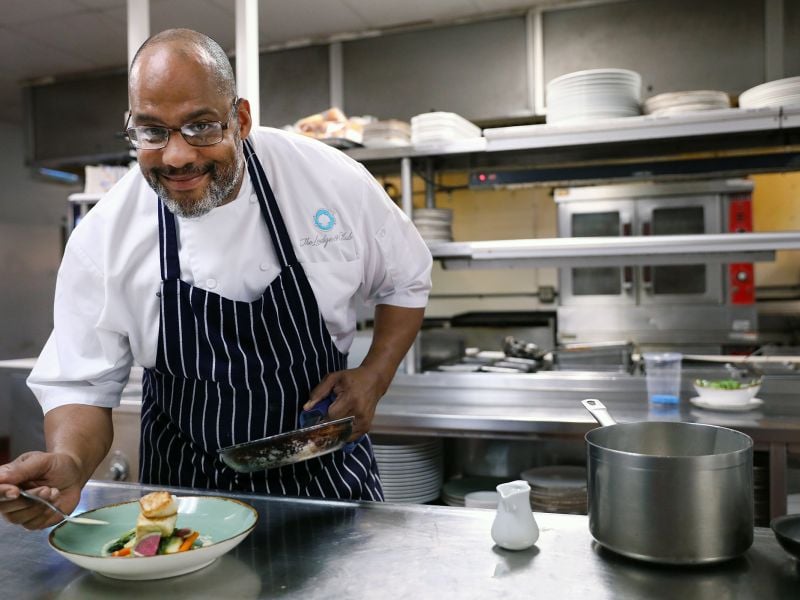 A chef plating a dish at the Lodge Restaurant