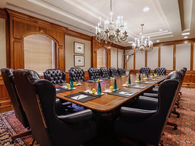 Large boardroom prepped for a meeting with luxurious leather chairs