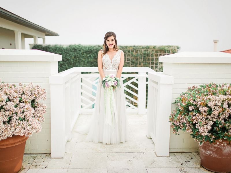 bride stands atop rooftop courtyard