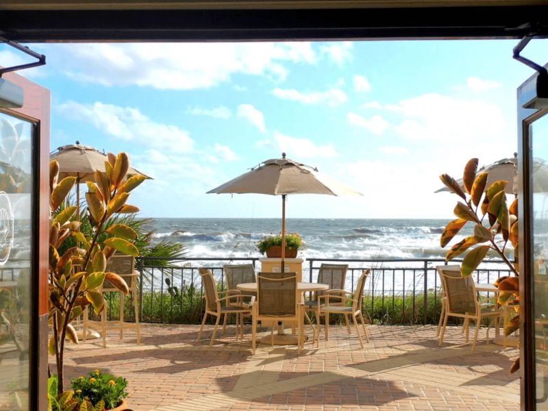 view of oasis patio through open doors