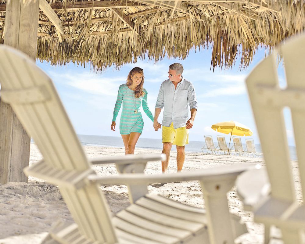 Couple walking into beach cabana