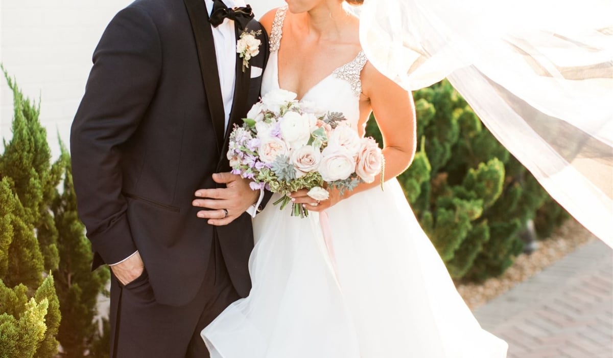 A groom kisses his smiling bride's forehead at Ponte Vedra Inn & Club.