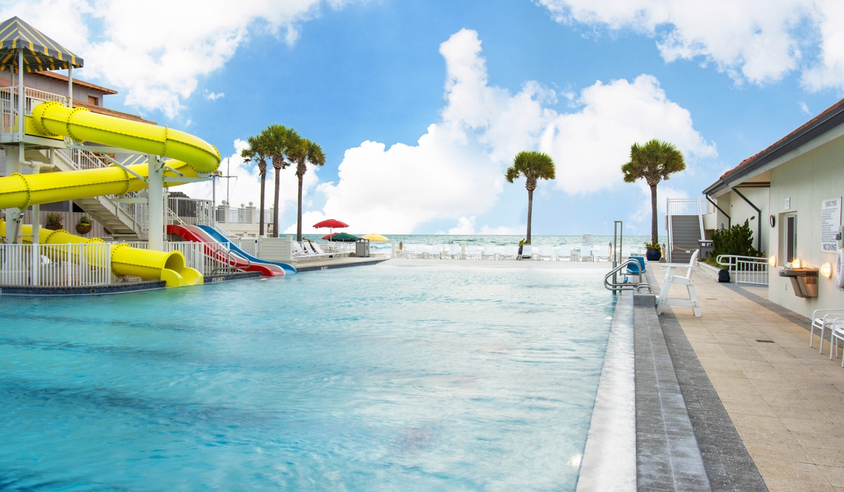 Outdoor kids pool with yellow water slide at the Inn