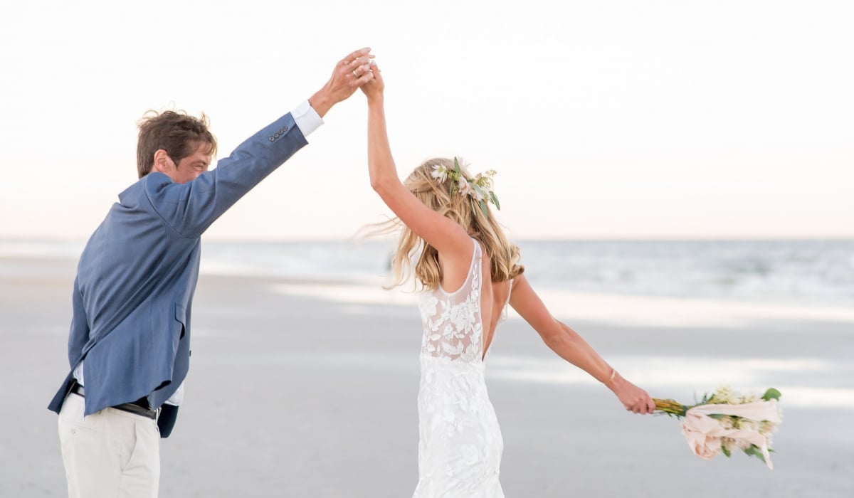 A bride and groom dance on the beach at Ponte Vedra Inn & Club.