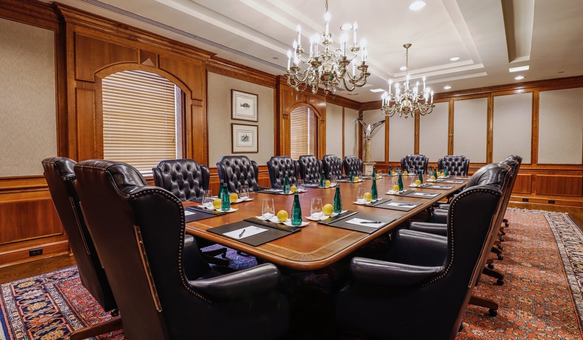 Large boardroom prepped for a meeting with luxurious leather chairs