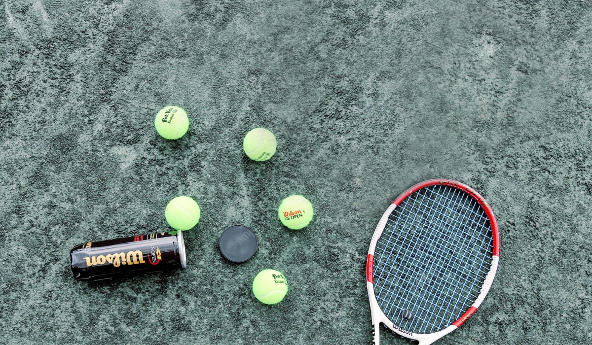 overhead shot of tennis racket and balls