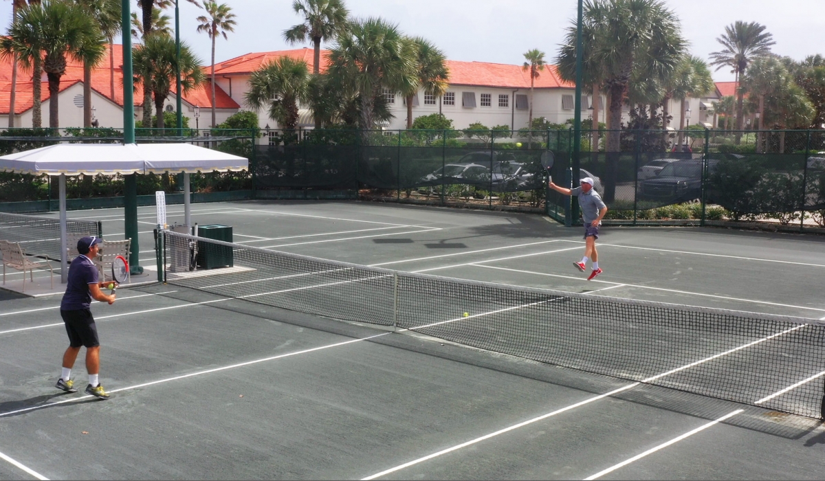 two men play a game of tennis