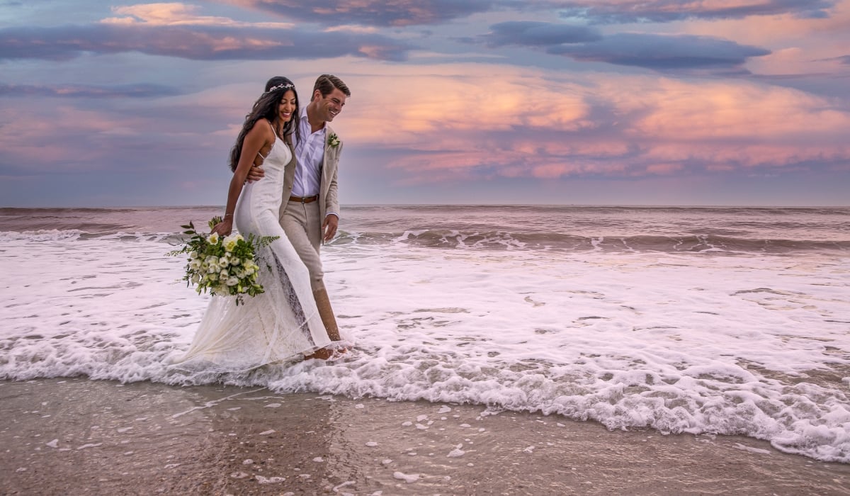 Brind and Groom walking on the beach at our Northeast Florida Wedding Venue