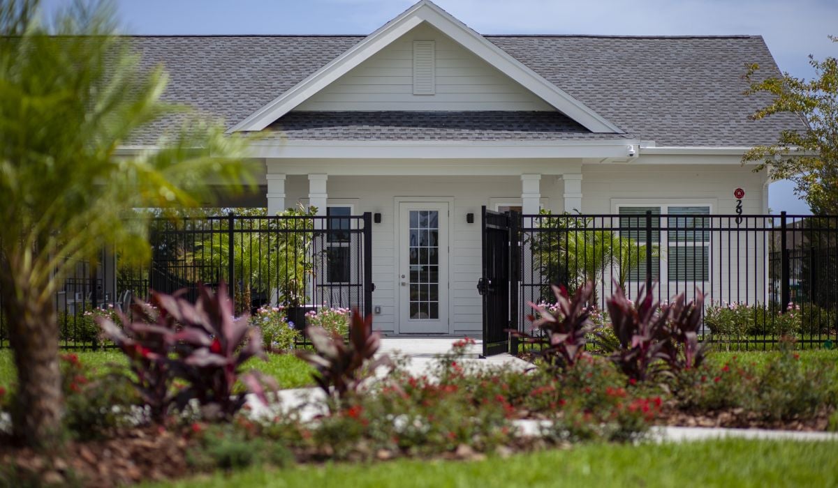 building with trees and entrance to tennis facility