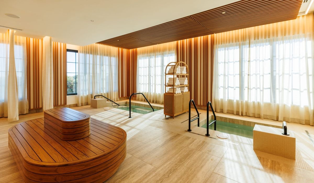 a wellness room with two small pools and a bench in the middle