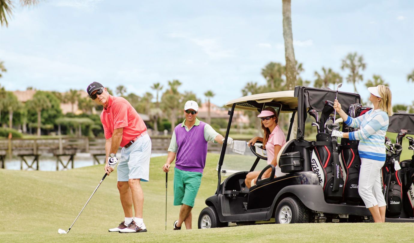 man sets up golf shot