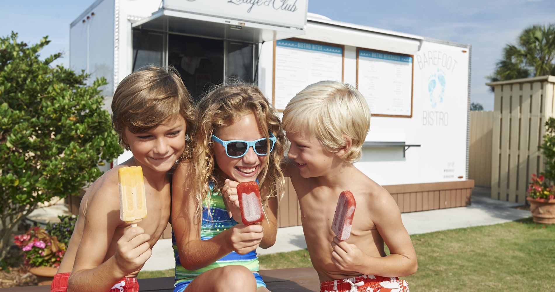 children eat popsicles in front of barefoot bistro