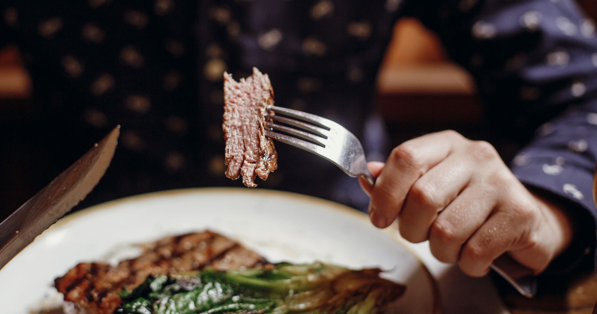 close up of man eating steak