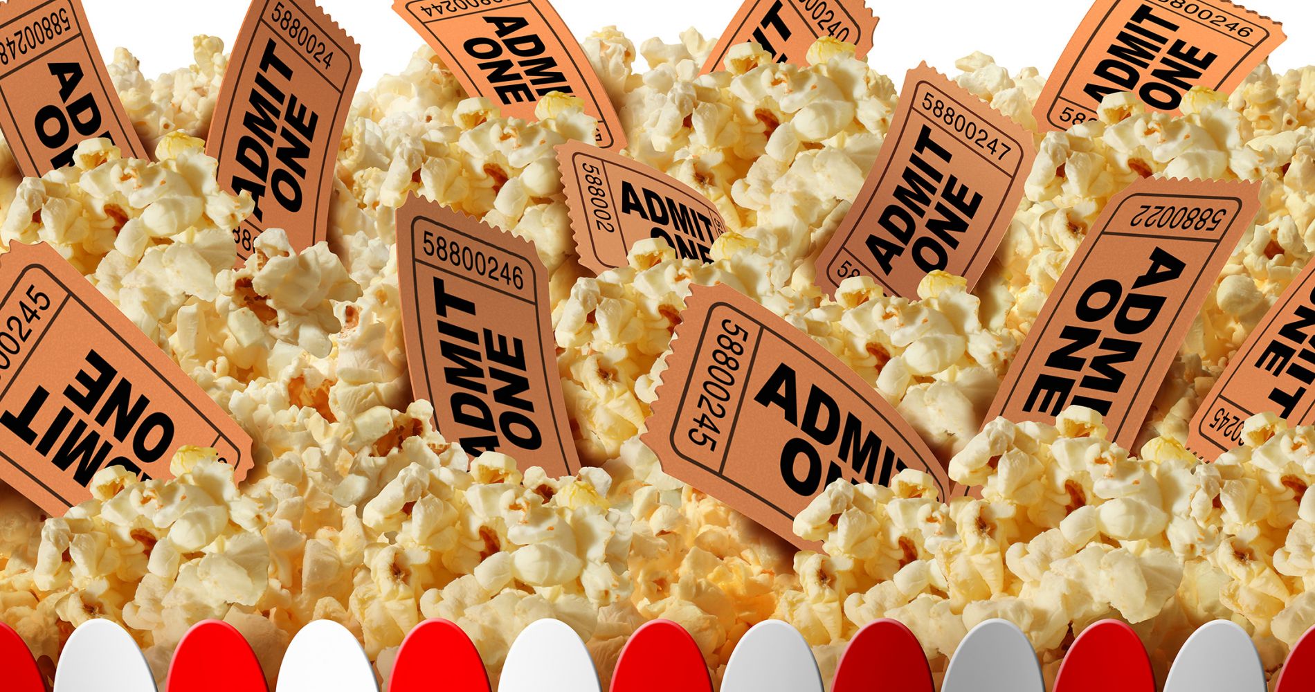 A red and white box holds popcorn, with paper movie stub tickets poking out from the popcorn.