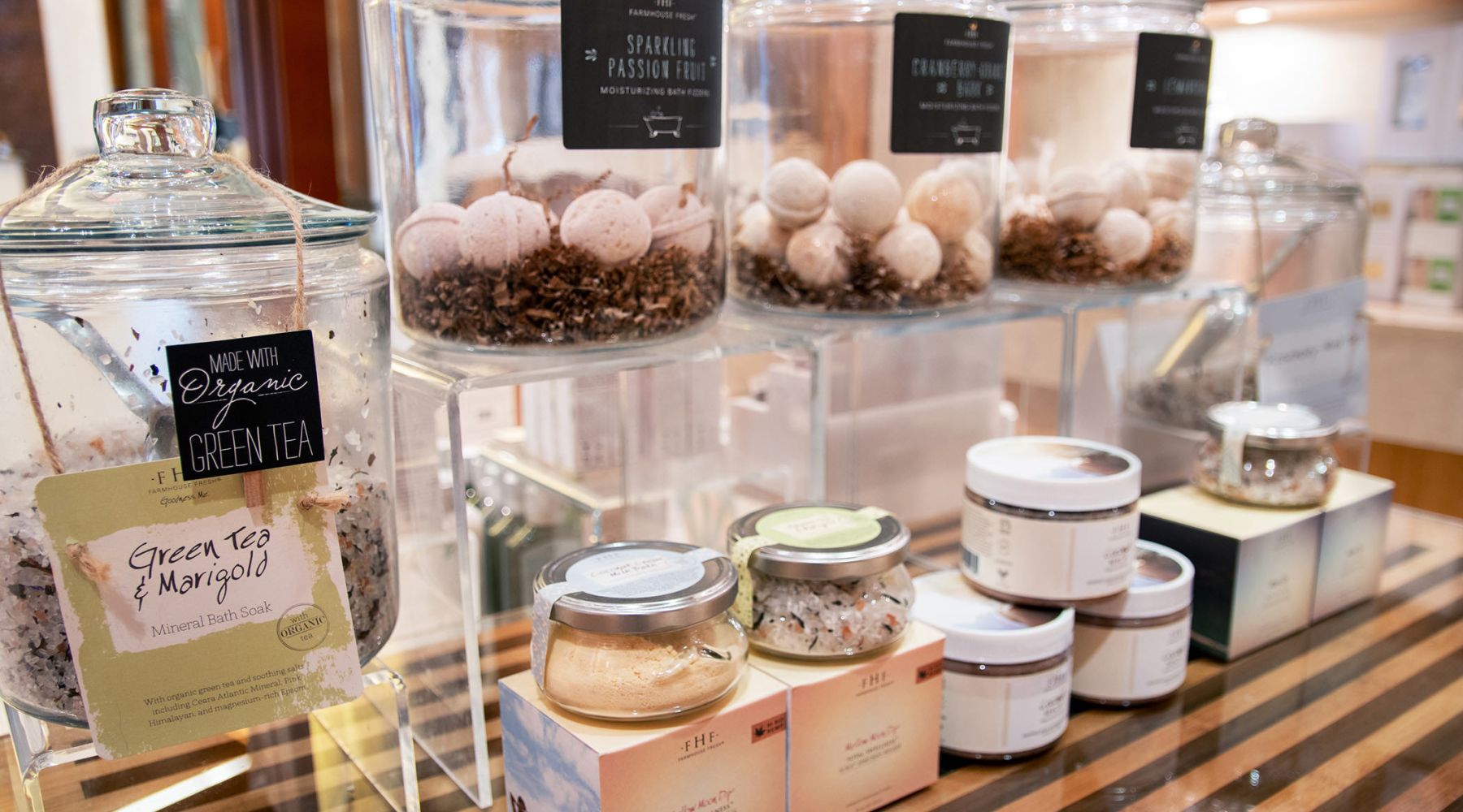 Display of luxurious bath salts and bath bombs on a table in the spa shop